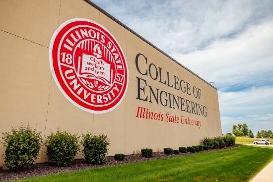 Tan College of Engineering building wall with a large Illinois State University seal and landscaped lawn.