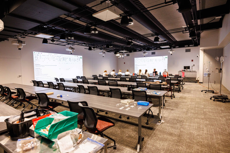 Students learn in a large lecture hall.